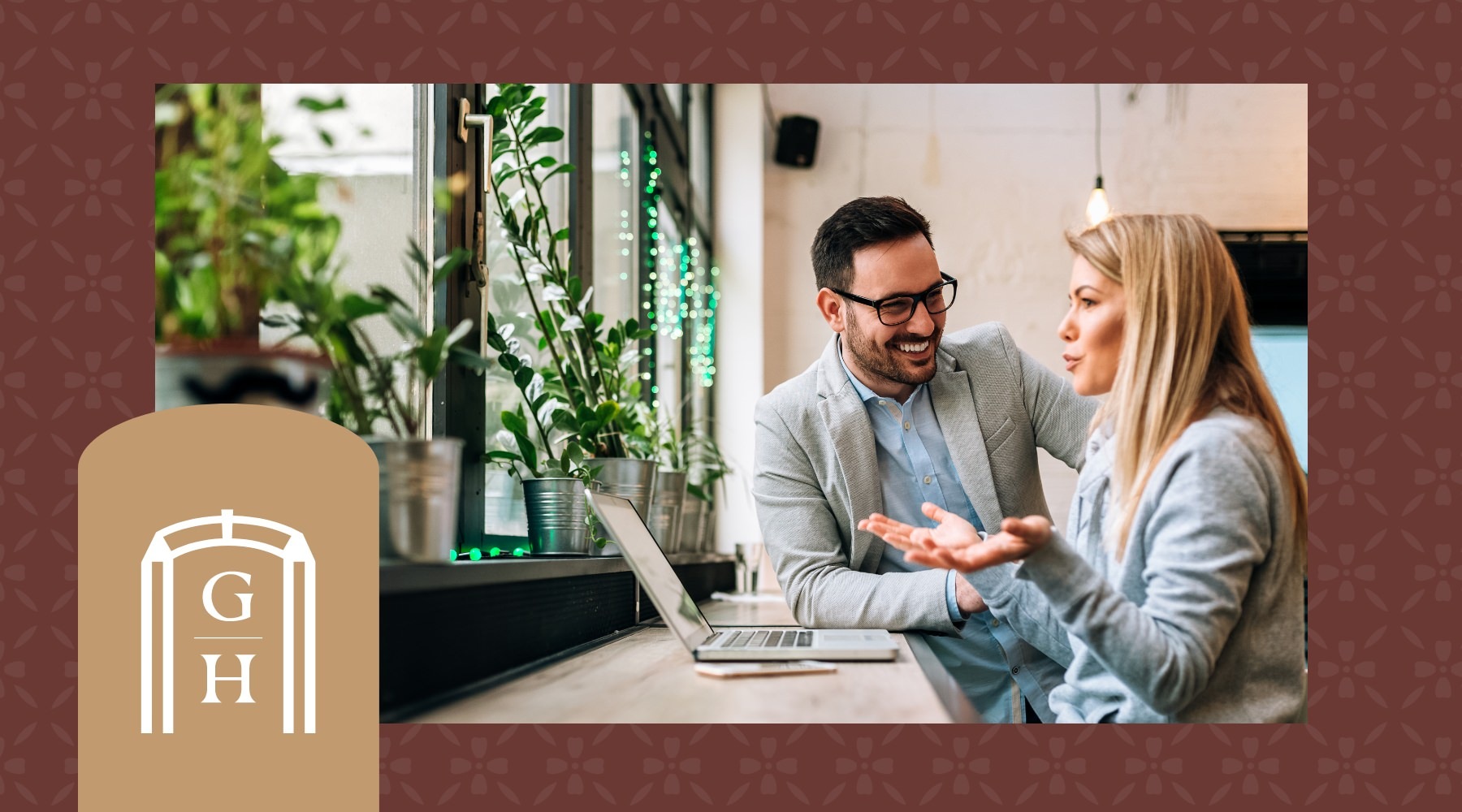 two people talking by plants and a laptop