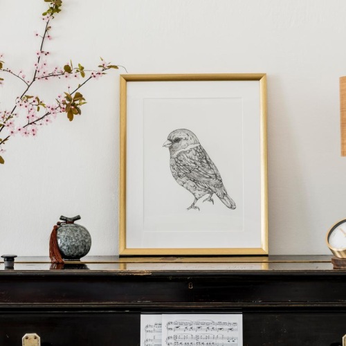 a picture frame and a lamp on a table
